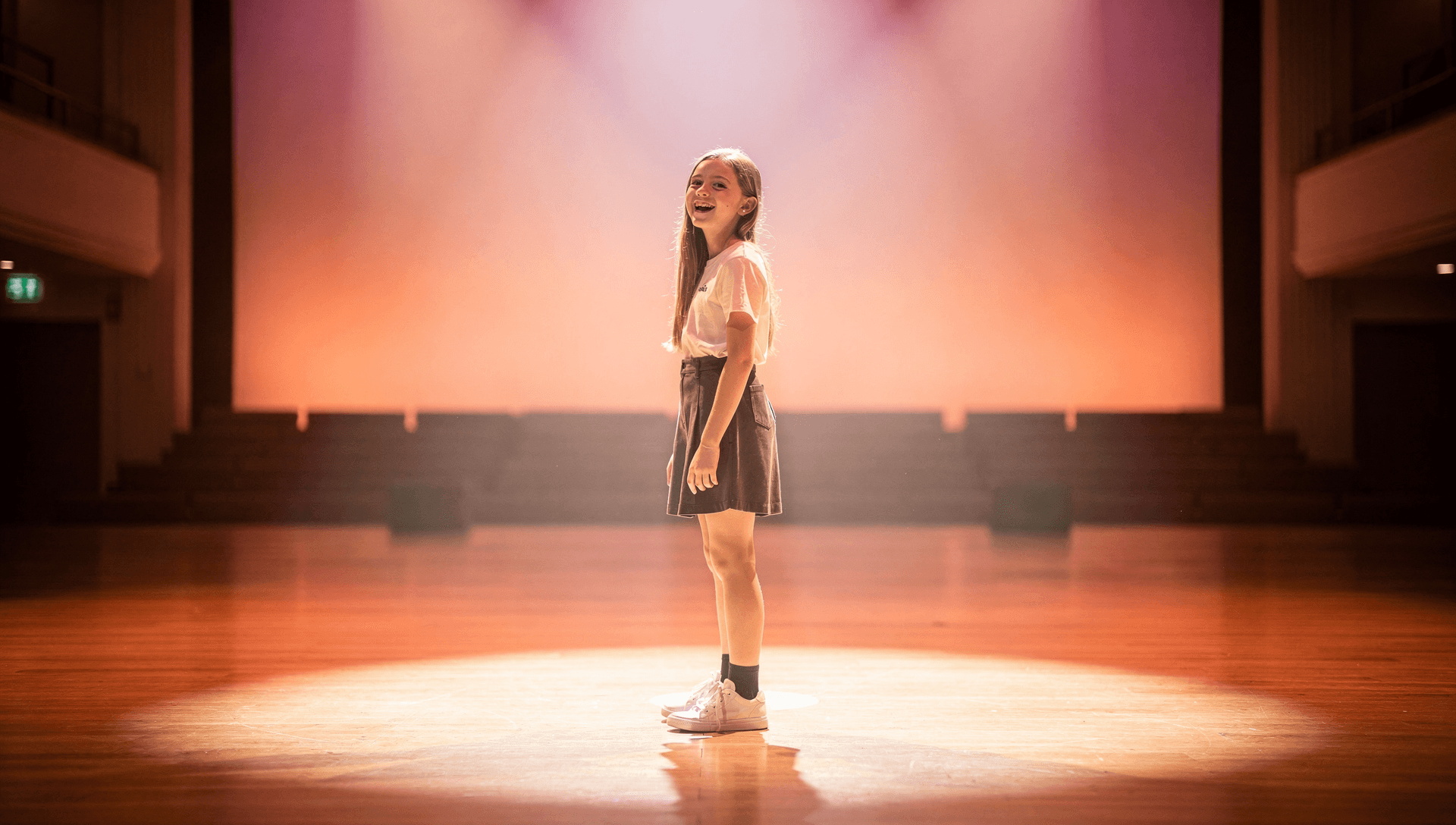 A young student standing on stage, symbolizing real stage readiness