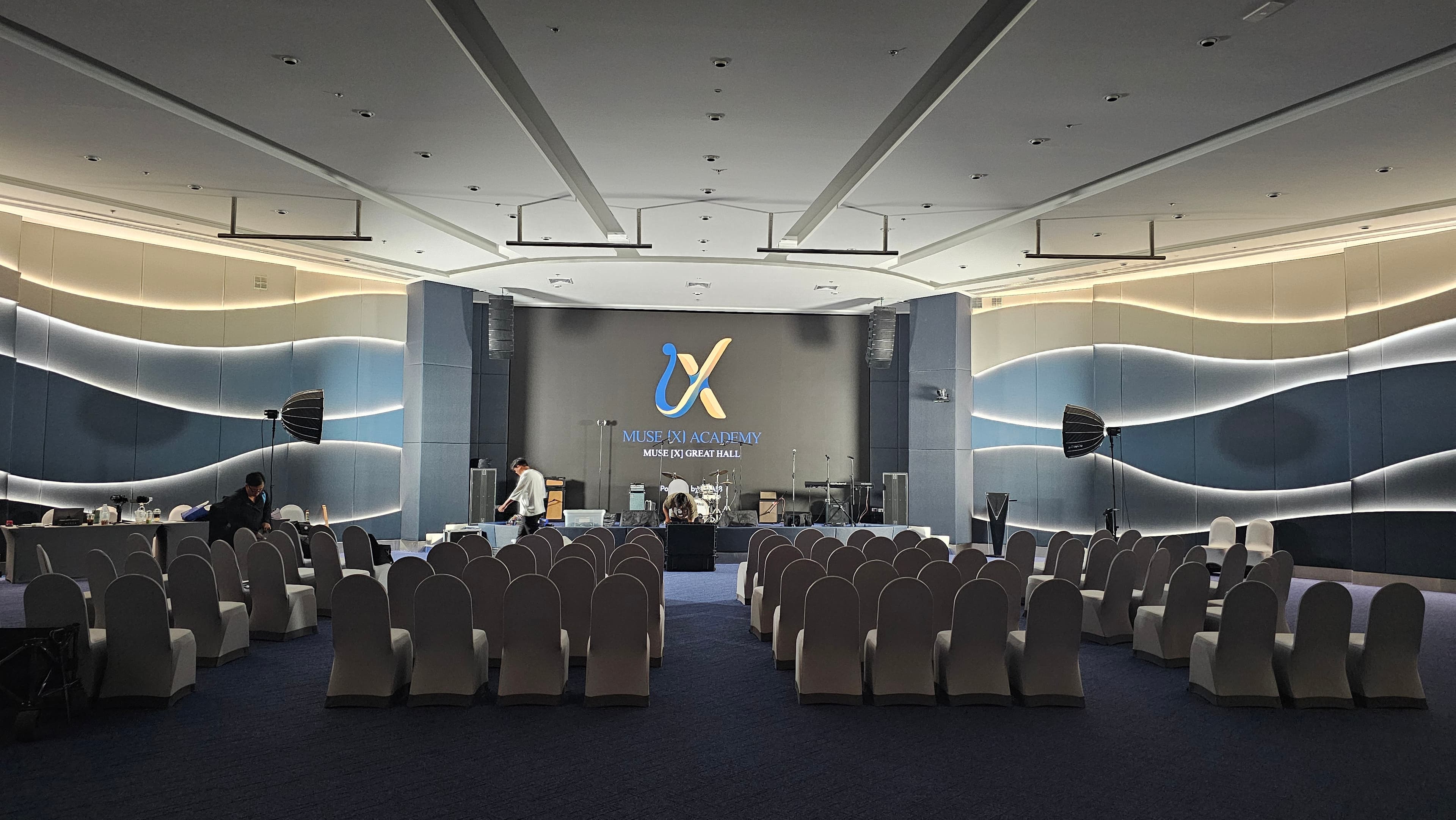 Wide view of The Great Hall with seating arranged before the Muse [X] stage.